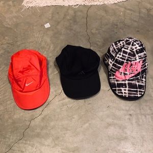Three women’s running hats